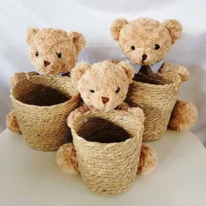 Natural seagrass storage basket with adorable plush teddy bear, ideal for Nordic home decor.