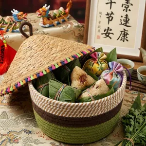 Handwoven cotton rope storage basket with straw lid, perfect for festive gifts and home decor.
