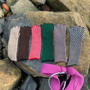 Detail view of stylish checkerboard knitted gloves in multi-colors, soft woolen texture for winter.