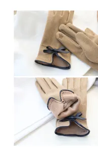 Detail view of womens winter touch screen gloves with warm fleece lining and cute bows.