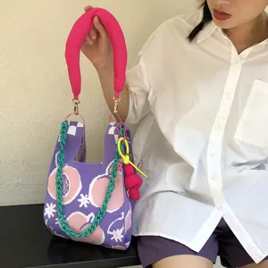Cute Japanese style knitted tote bag with peach pattern, pink handle and green chain detail.