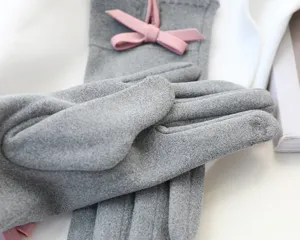 Grey faux suede winter gloves for women with pink bow detail and touch screen feature
