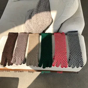 Detailed view of multi-color checkered knitted gloves, soft wool wool in various shades.