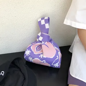 Knitted knot wrist bag with cute peach and flower pattern, purple chic fashion handbag for women.