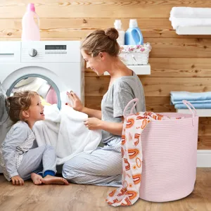 Pink woven cotton rope laundry basket detail showcasing soft texture and sturdy double handles.