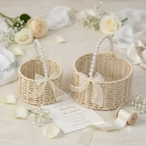 Exquisite woven flower basket with pearl handle and elegant ribbon bow for wedding party decor.