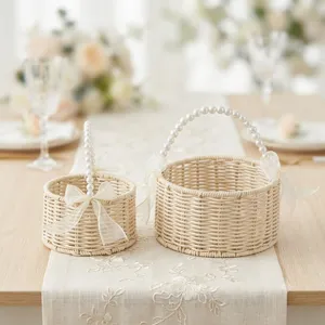 Rattan woven wedding gift basket with pearl handle and bow, elegant floral basket for party.