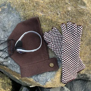 Detailed view of brown knit balaclava hood and stylish checkerboard touchscreen gloves set.