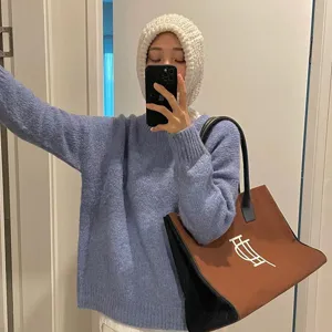 Detailed view of cozy knit balaclava hat and warm winter sweater in casual daily outfit.