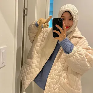 Cozy winter knitted balaclava hat and quilted jacket outfit for women, warm and stylish.