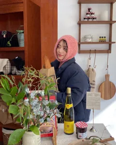 Cozy pink knitted balaclava hat detail, soft winter warm texture for daily warm wear.