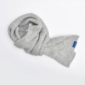 Detailed shot of the soft grey knit cross scarf, showcasing the cozy texture and weave.