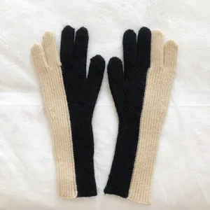 Close-up detail view of stylish color-block knit gloves, soft winter thermal texture.