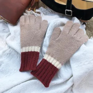 Cozy knit glove detail shot featuring a cozy three-tone color block design and warm texture.