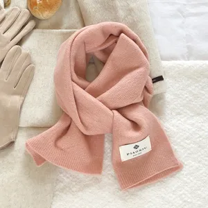 Cozy pink knitted wool scarf detail view, soft solid color winter warm neck warmer for daily wear.