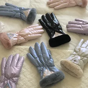 Detail view of multi-color fleece-lined winter touch screen gloves with furry cuffs.