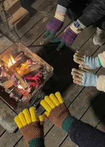 Outdoor winter knit gloves detail showing color-blocking design and warm woolen texture.