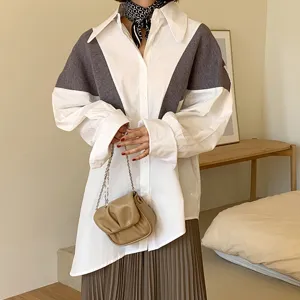 Chic colorblock long-sleeve shirt with pleated skirt and elegant chain bag for daily wear.