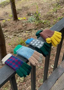 Winter colorblock knit gloves detail showing multi-color patterns and cozy warm texture.