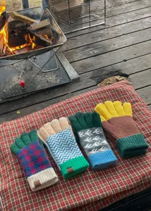 Detailed view of colorful knit gloves featuring cozy winter patterns and vibrant color blocking.