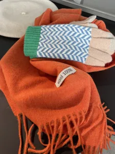 Knit gloves and wool scarf set winter warm colorful geometric patterns detail shot