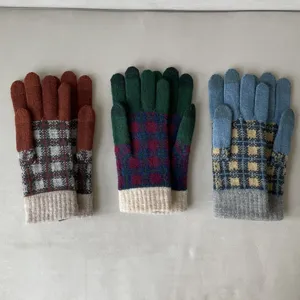 Close-up of winter knitted plaid gloves detail, colorful plaid pattern, warm knit texture.