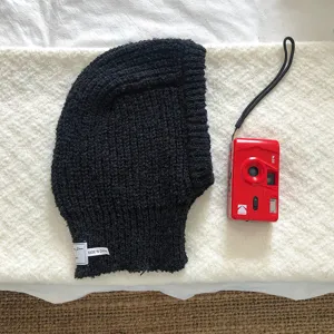Black knitted balaclava winter warm earflap beanie hat detail view fashion cozy casual accessory