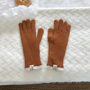 Cozy winter knitted gloves detail shot, warm caramel wool, perfect for cold weather chic style.
