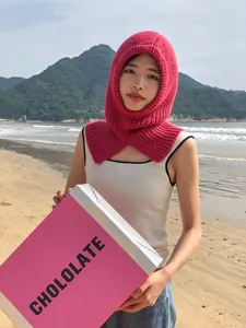 Detailed view of women's warm knitted balaclava hood and scarf set in bright pink.