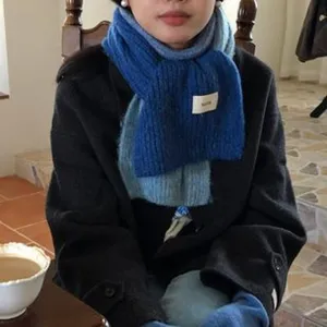 Dettaglio della sciarpa in maglia sfumata, morbido accessorio invernale caldo per outfit.
