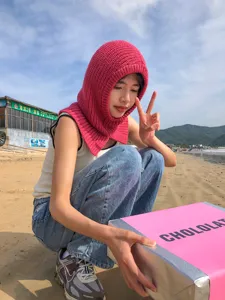 Stylish pink knitted balaclava hat and scarf all-in-one, warm winter fleece knit headwear.