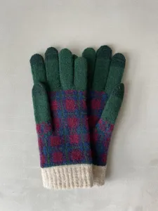 Detailed close up of winter color block knitted gloves, warm thermal stretch mittens.