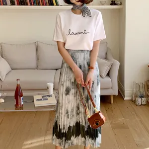 Detailed view of fashionable silk scarf outfit matching t-shirt and pleated skirt inside.