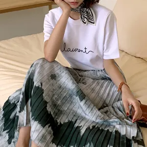 Detailed view of the stylish white t-shirt with print and tie-dye skirt outfit.