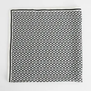 Detailed close-up view of a classic black and white chain pattern silk square scarf.