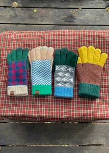 Winter color-block knit gloves details, cozy woolen thermal mittens with vintage patterns and ribbed cuffs.