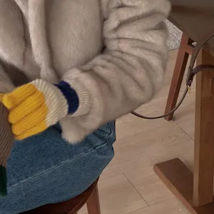 Close-up detail of colorful striped knit five-finger gloves, warm wool winter handwear accessory.