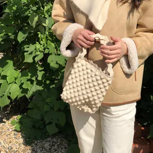 Beige gebreide mini tas met bubbeltextuur en golvend handvat, chique dagelijkse handtas stijl.