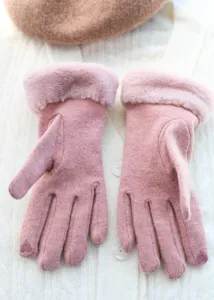 Close up of women winter pink knit gloves with plush cuffs warm cute style soft fabric detail view