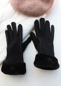 Close-up of black winter women gloves with warm fur cuffs and elegant white stitching details.