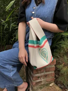 Handmade knitted tote bag for women with cute heart pattern and colorful striped design daily use.