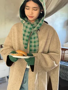 Detailed shot of women autumn winter green plaid integrated hat knitted scarf and warm coat.