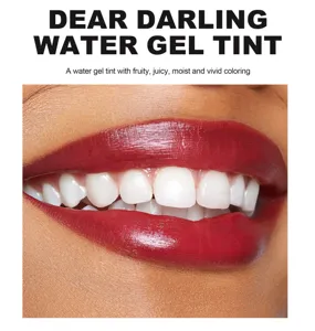 Lip tint detail shot showing glossy dark red lip makeup swatch and smooth texture.