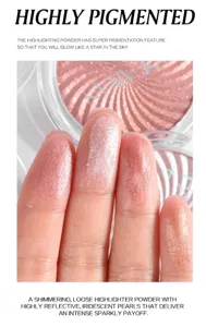 Detailed shot showing shimmering powder highlighter swatches on fingers with brilliant reflective finish.