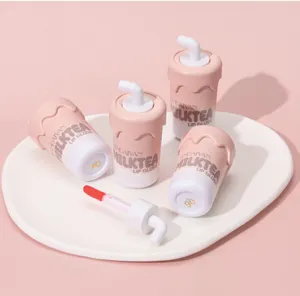 Milk tea cup lip gloss close-up view, cute creative design with applicator brush and pink tone.