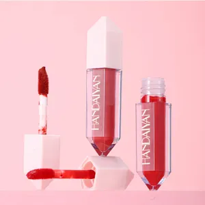 Close-up of liquid matte lip gloss showing diamond cap, applicator brush, and vivid red tint.