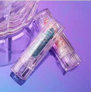 Close-up shot of two clear plastic tube lipsticks with blue and pink balm in a studio setup.
