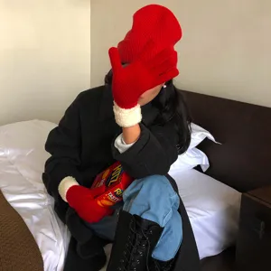 Red knit beanie and warm winter gloves set, cozy woolen accessory for cold weather daily wear.