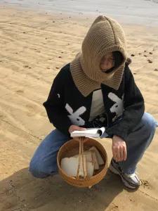 Cozy knitted balaclava hood and scarf combo, warm winter head and neck protection detail.