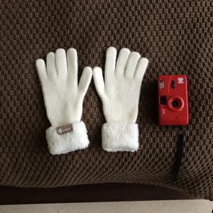 White knitted winter gloves with plush cuffs, warm thermal cold-proof daily wear detail shot.